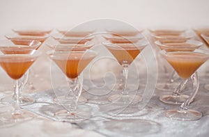 Martini glasses with peach juice