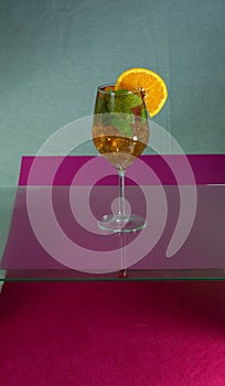 Martini rosato on the glass table with orange and peppermint