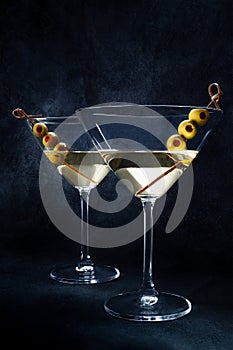 Martini. Two glasses of dirty martini cocktails with vermouth and olives