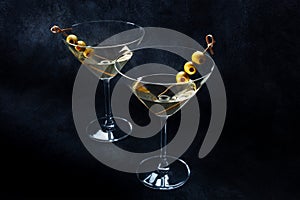 Martini. Two glasses of dirty martini cocktails with vermouth and olives