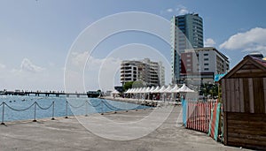 Martinique-Pier scene with marketplace and urban buildings