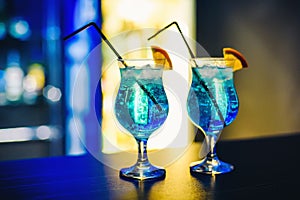 Martinis in glasses with ice on the bar with orange