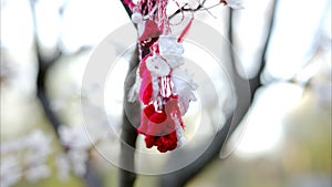 A martisor hanging on a tree branch in t