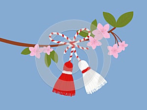 Martisor talisman on a branch. Traditional accessory for holiday of early spring in Romania and Moldova. Red and White spring