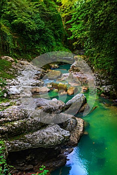 MARTVILI, GEORGIA: Abasha River with azure water in Martvili Canyon on a summer day.