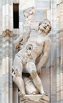 Martyrdom of Saint Erasmus, statue on the Milan Cathedral, Duomo di Santa Maria Nascente, Milan, Italy