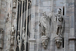 The marvellous statue are decorating on the white wall surrounding Duomo milano, The mistery art on external building