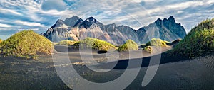 Marvelous afternoon view of Stokksnes cape with Vestrahorn Batman Mountain on background. Panoramic summer landscape with black