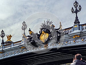 Marvelous details of historic bridge Pont Alexandre III over the River Seine in Paris France. View from touristic boat