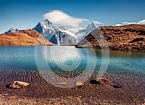 Marvelous morning view of Bachalp lake Bachalpsee, Switzerland. Wonderful autumn scene of Swiss alps, Grindelwald, Bernese Oberl