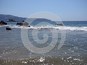 Marvelous view of rocks at bay of ACAPULCO city in Mexico with Pacific Ocean waves on sandy beach landscape