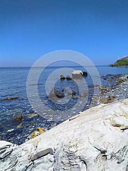 Marvelous view of white and black stones on the beach during low tide in Manatuto beach, Timor-Leste. photo