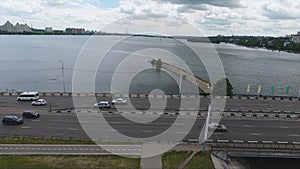 Marvelous view of wide dark river dividing city on two parts on summer day