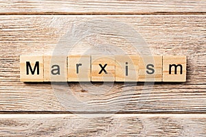 Marxism word written on wood block. marxism text on table, concept