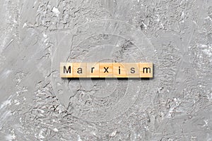 Marxism word written on wood block. marxism text on table, concept