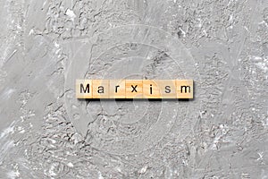 Marxism word written on wood block. marxism text on table, concept photo