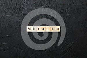 marxism word written on wood block. marxism text on table, concept photo