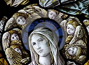 Mary with angels around her head (stained glass)