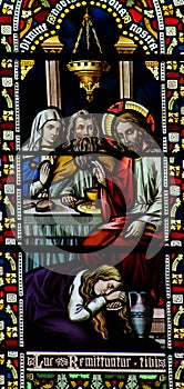 Mary Magdalene washing the feet of Jesus in stained glass