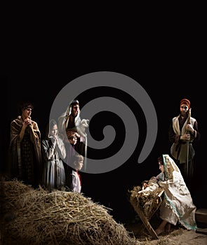 Mary sits in the stable near the manger with the baby
