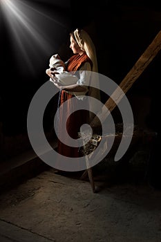 Mary in the stable near the manger with the baby