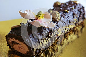 Marzipan pink flower on a homemade chocolate cake roll