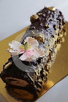 Marzipan pink flower on a homemade chocolate cake roll