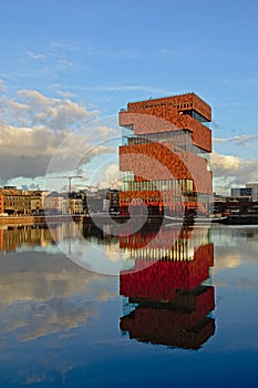 MAS museum reflecting in the water of Willemdok dock in Antwerp