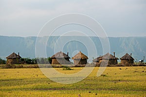 Masai village near Ngorongoro crater and Mto Wa Mbu. Small Masai huts in African savanna, Tanzania