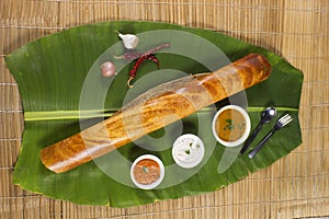 Masala dosa on banana leaf with both sambar and coconut chutney