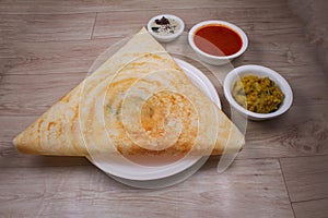 Masala dosa is a South Indian dish that is served with sambhar and coconut rubble. Selective focus