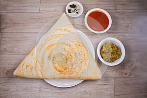 Masala dosa is a South Indian dish that is served with sambhar and coconut rubble. Selective focus