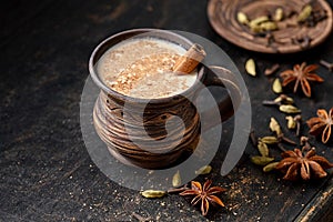 Masala pulled tea chai latte hot Indian sweet milk spiced drink, ginger, fresh spices and herbs blend