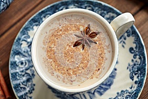 Masala tea chai latte homemade traditional hot Indian sweet milk with spices, herbs organic infusion