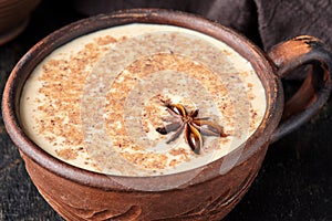 Masala tea chai latte traditional homemade warm Indian sweet milk spiced drink, ginger, fresh spices blend