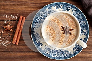 Masala tea chai latte traditional hot Indian sweet milk with spices, cinnamon stick, herbs blend organic infusion