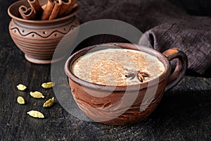 Masala tea chai latte traditional warm Indian sweet milk spiced drink, ginger, green cardamom, spices blend