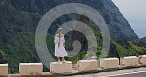 Masca gorge village. Elegant woman enjoying tropical nature view. Rear view. Inspired freedom girl admiring landscape