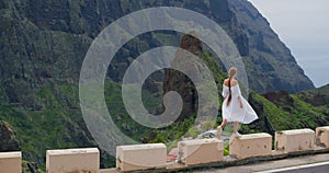 Masca gorge village. Elegant woman enjoying tropical nature view. Rear view. Inspired freedom girl admiring landscape