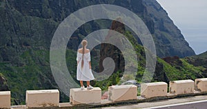Masca gorge village. Elegant woman enjoying tropical nature view. Rear view. Inspired freedom girl admiring landscape