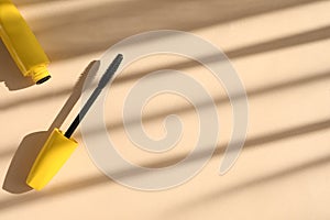 Mascara on beige background, flat lay with space for text. Makeup product