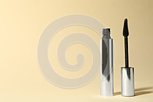 Mascara on beige background, space for text