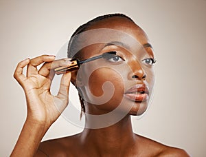 Mascara, black woman and makeup for beauty cosmetics, makeover and eyelash extension in studio on brown background. Face