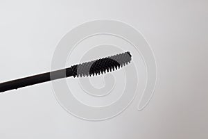 Mascara brush on a white background. spa and makeup concept. Top view. Flat lay composition
