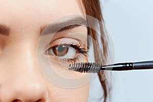 Mascara. Closeup Of Beautiful Young Woman Face With Beauty Makeup,