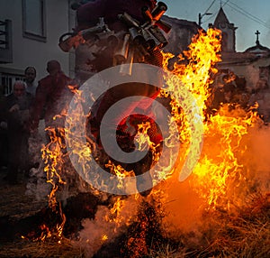 Mascaraed People jumping cross bonfires in an ancient tradition of Carnival in Vila Boa de OusilhÃ£o.