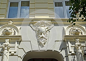 Mascarons of man and lions on the facade of the building. Sovetsk, Kaliningrad region