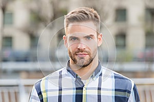 Masculine appearance. Handsome man unshaven face and stylish hair. Caucasian man urban background. Bearded man in casual