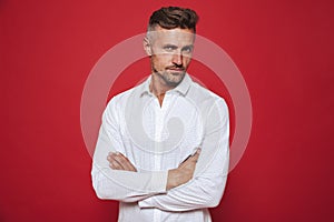 Masculine brunette man 30s with stubble in white shirt looking o