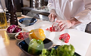 Masculine hands of the chef cutting paper in the kitchen